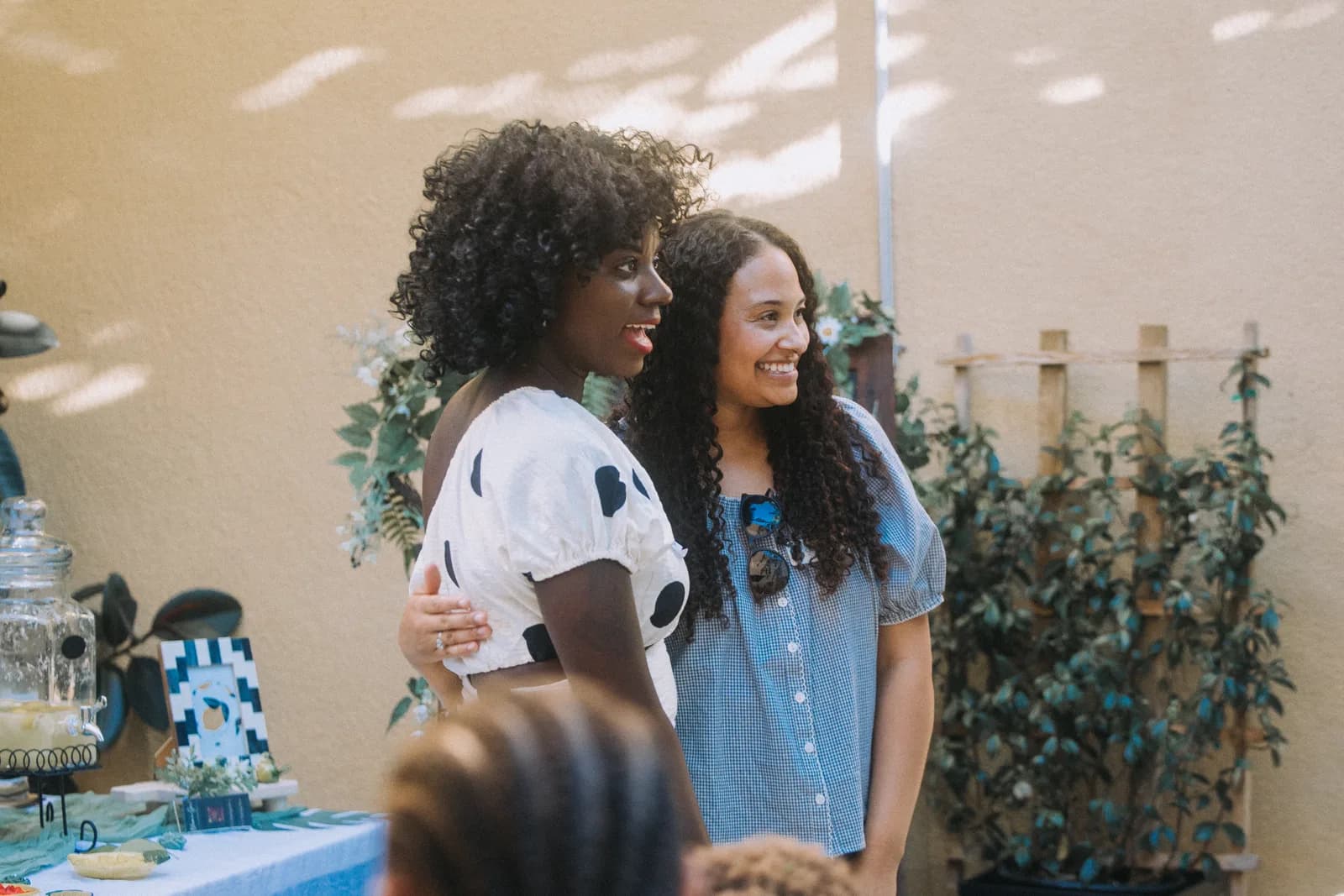 Two women smiling together at a Sacramento Tabernacle outdoor community event